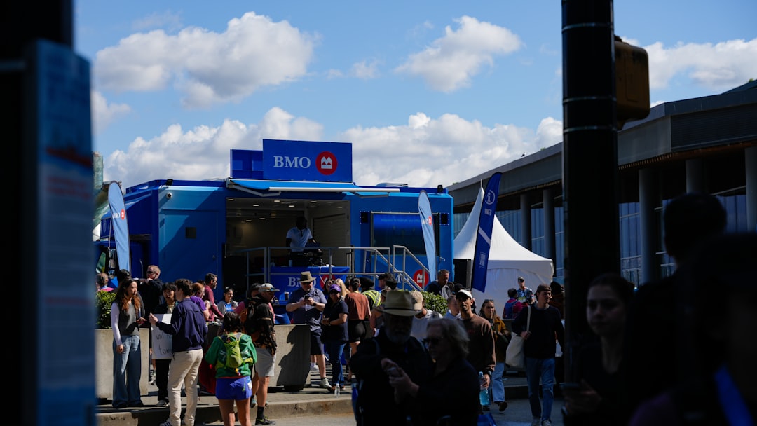 people-gathered-around-a-blue-mobile-unit-with-bmo-logo-p4nqmrusljo