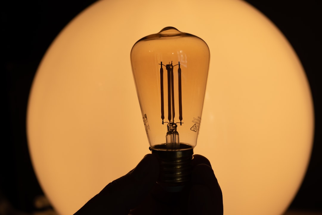 lightbulb in the dark with gold lights in the background, great ideas coming, creativity is rising. Free to use license. We would be very grateful if you would please attribute source back to https://dlxmedia.hu/